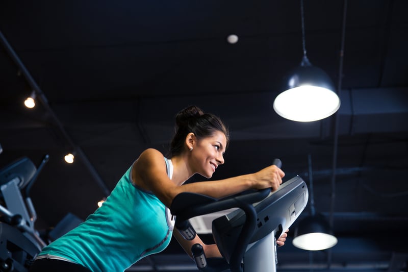 Sports woman workout on exercises machine in fitness gym-1